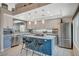 A bright kitchen with a center island, two-tone cabinets, and stainless steel appliances at 8725 Hawk Canyon St, Henderson, NV 89074