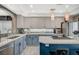Charming kitchen with grey cabinets, a center island, and modern stainless steel appliances at 8725 Hawk Canyon St, Henderson, NV 89074