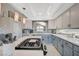 This kitchen features white cabinets, a gas range, a breakfast bar, and stainless steel appliances at 8725 Hawk Canyon St, Henderson, NV 89074