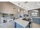 Well-lit kitchen boasts a center island, grey backsplash, and modern appliances at 8725 Hawk Canyon St, Henderson, NV 89074