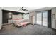 This main bedroom features an accent wall, carpet flooring, a ceiling fan, and sliding glass door to a balcony at 8725 Hawk Canyon St, Henderson, NV 89074