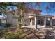 Home featuring a covered patio and xeriscaped backyard with desert plants and trees at 8771 Martinique Bay Ln, Las Vegas, NV 89147