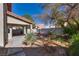 A cozy backyard featuring shade trees and desert plants adding a splash of color and texture to the landscape at 8771 Martinique Bay Ln, Las Vegas, NV 89147