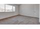 Bedroom featuring carpeted floors and a large window for ample natural light at 8771 Martinique Bay Ln, Las Vegas, NV 89147
