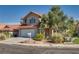 Inviting two-story home with a red tile roof, a two-car garage, and desert landscaping at 8771 Martinique Bay Ln, Las Vegas, NV 89147