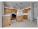 Spacious kitchen with wooden cabinets, tile floors, and stainless steel appliances at 8771 Martinique Bay Ln, Las Vegas, NV 89147