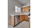 Kitchen featuring stainless steel appliances, wooden cabinets, and tile backsplash at 8771 Martinique Bay Ln, Las Vegas, NV 89147