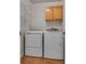 Convenient laundry room with washer, dryer, shelving and cabinets at 8771 Martinique Bay Ln, Las Vegas, NV 89147