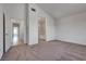 Open living room adjacent to bathroom offers neutral carpet and paint at 8771 Martinique Bay Ln, Las Vegas, NV 89147