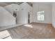 Spacious living room featuring high ceilings, carpet flooring, a modern light fixture, and abundant natural light at 8771 Martinique Bay Ln, Las Vegas, NV 89147