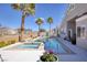 Lush backyard with a pool, spa, patio area, and mature trees for privacy at 8894 Don Horton Ave, Las Vegas, NV 89178