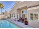 Private backyard featuring a sparkling pool, patio, and lush landscaping at 8894 Don Horton Ave, Las Vegas, NV 89178