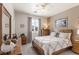 Bedroom with a bed, ceiling fan, and a large window offering plenty of natural light at 8894 Don Horton Ave, Las Vegas, NV 89178