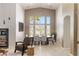 Bright dining room with tall windows, modern furniture, and elegant decor at 8894 Don Horton Ave, Las Vegas, NV 89178