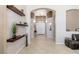 Entry hall featuring neutral walls, tile floors, arched doorways, and floating shelves at 8894 Don Horton Ave, Las Vegas, NV 89178