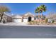 Charming single-story home featuring a three-car garage, desert landscaping, and tile roof at 8894 Don Horton Ave, Las Vegas, NV 89178