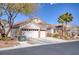 Charming single-story home featuring a three-car garage, desert landscaping, and tile roof at 8894 Don Horton Ave, Las Vegas, NV 89178