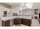 Open kitchen with breakfast bar and views into the living room and fireplace at 8894 Don Horton Ave, Las Vegas, NV 89178