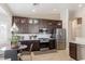 Bright kitchen with stainless appliances, dark cabinetry, and a breakfast nook at 8894 Don Horton Ave, Las Vegas, NV 89178