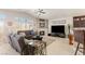 Inviting living room featuring a fireplace, large windows, and comfortable seating at 8894 Don Horton Ave, Las Vegas, NV 89178