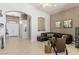 Open-concept living room features neutral walls, tile floors, and an archway to the entry hall at 8894 Don Horton Ave, Las Vegas, NV 89178