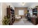 Comfortable home office with bookshelves, a cozy chair, and a well-lit workspace at 8894 Don Horton Ave, Las Vegas, NV 89178