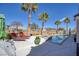 Inviting backyard oasis with a sparkling pool, spa, lounge chairs and lush palm trees at 8894 Don Horton Ave, Las Vegas, NV 89178