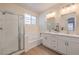 Bright bathroom features a glass shower, soaking tub, and double sink vanity at 9193 Black Slate St, Las Vegas, NV 89123
