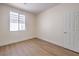 Bright bedroom features a window allowing natural light and light wood-look floors at 9193 Black Slate St, Las Vegas, NV 89123