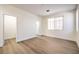 Bright bedroom features a window allowing natural light and light wood-look floors at 9193 Black Slate St, Las Vegas, NV 89123