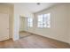 Bright bedroom featuring hardwood floors, a large window, and a closet with sliding mirror doors at 9193 Black Slate St, Las Vegas, NV 89123