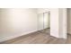 Bright bedroom features a mirrored closet door and light wood-look floors at 9193 Black Slate St, Las Vegas, NV 89123