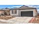 Charming single story home with a gray garage door and low maintenance desert landscaping at 9193 Black Slate St, Las Vegas, NV 89123