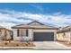 Charming single story home with a gray garage door and low maintenance desert landscaping at 9193 Black Slate St, Las Vegas, NV 89123
