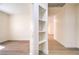 Bright hallway featuring built-in shelving, light walls, and light wood-look floors at 9193 Black Slate St, Las Vegas, NV 89123