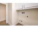 Convenient laundry room with washer and dryer hookups and extra storage cabinets overhead at 9193 Black Slate St, Las Vegas, NV 89123