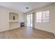 Bright living room with fireplace, recessed lighting, and sliding glass door at 9193 Black Slate St, Las Vegas, NV 89123