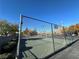 View of the community basketball court behind a chain link fence with parking and landscaping around it at , Henderson, NV 89014
