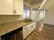 Close up on updated granite countertops, stainless steel sink, and white kitchen cabinetry at , Henderson, NV 89014
