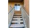 Condo entryway up concrete stairs featuring a window, metal rails and the unit number at , Henderson, NV 89014