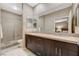 Bathroom featuring double sinks with a large mirror and a glass enclosed shower at 1541 Unison Way # 102, Las Vegas, NV 89135