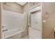 Bright bathroom featuring a bathtub with a white tile surround and a white shower curtain at 1541 Unison Way # 102, Las Vegas, NV 89135