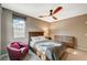 Well-lit bedroom with ceiling fan, a window and a comfortable queen size bed at 1541 Unison Way # 102, Las Vegas, NV 89135
