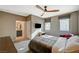 Bright bedroom with a ceiling fan, two windows, and a comfortable bed at 1541 Unison Way # 102, Las Vegas, NV 89135