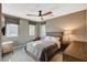 Spacious bedroom featuring a ceiling fan, two windows, and a queen bed with grey linens at 1541 Unison Way # 102, Las Vegas, NV 89135
