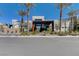 Community clubhouse featuring modern architecture, desert landscaping, and palm trees at 1541 Unison Way # 102, Las Vegas, NV 89135