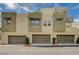 Townhouses featuring attached garages and modern exterior designs with a view of the numbered addresses above at 1541 Unison Way # 102, Las Vegas, NV 89135