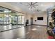 Spacious gym room with mirrored wall, exercise equipment, and wood-look flooring, perfect for fitness activities at 1541 Unison Way # 102, Las Vegas, NV 89135