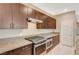 Kitchen with stainless steel oven, a range top, and sleek cabinets and countertops at 1541 Unison Way # 102, Las Vegas, NV 89135