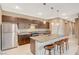 Modern kitchen featuring stainless steel appliances and a large island with stylish bar stool seating at 1541 Unison Way # 102, Las Vegas, NV 89135